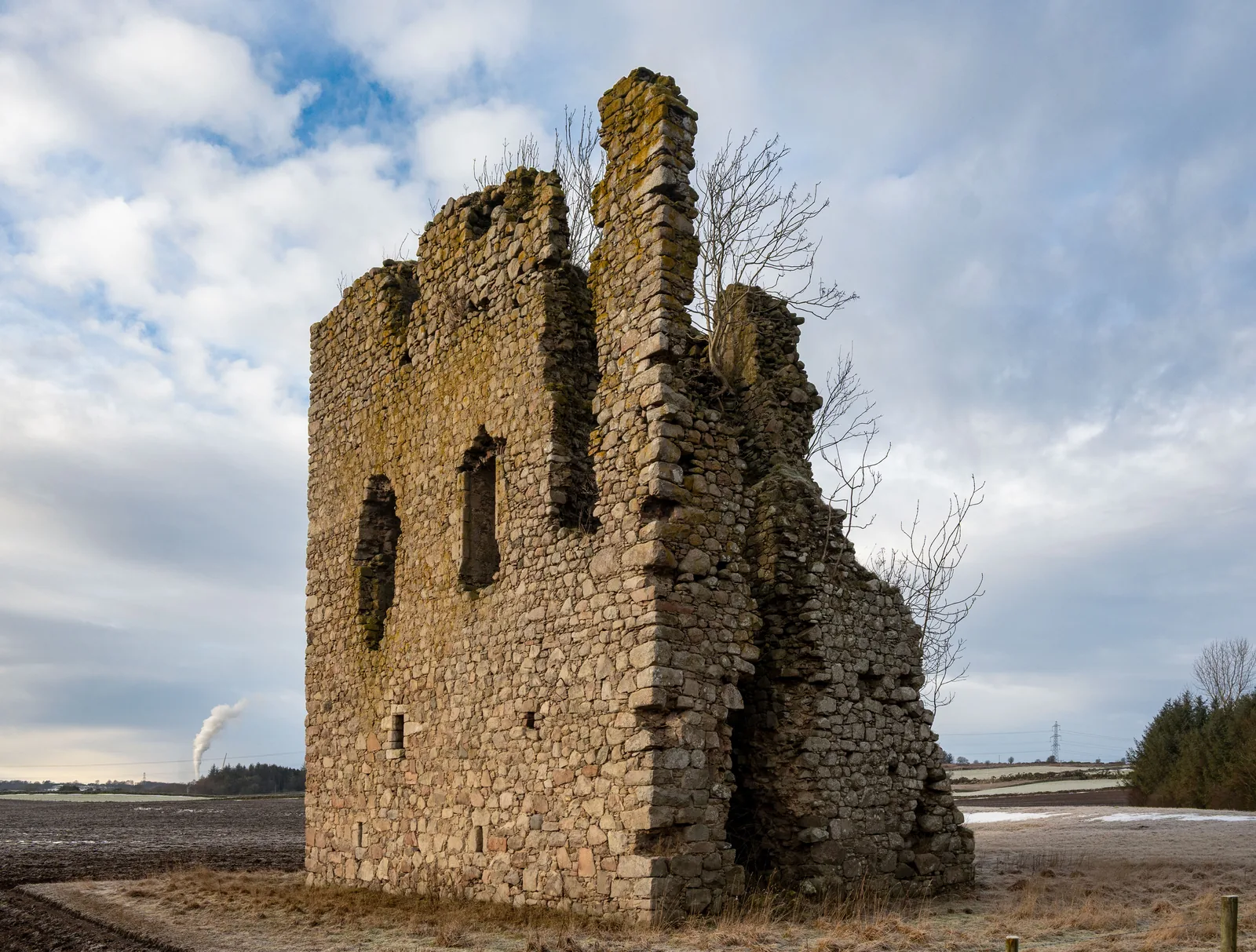 Hallforest Castle rising above a winter field outside Kintore in Aberdeenshire