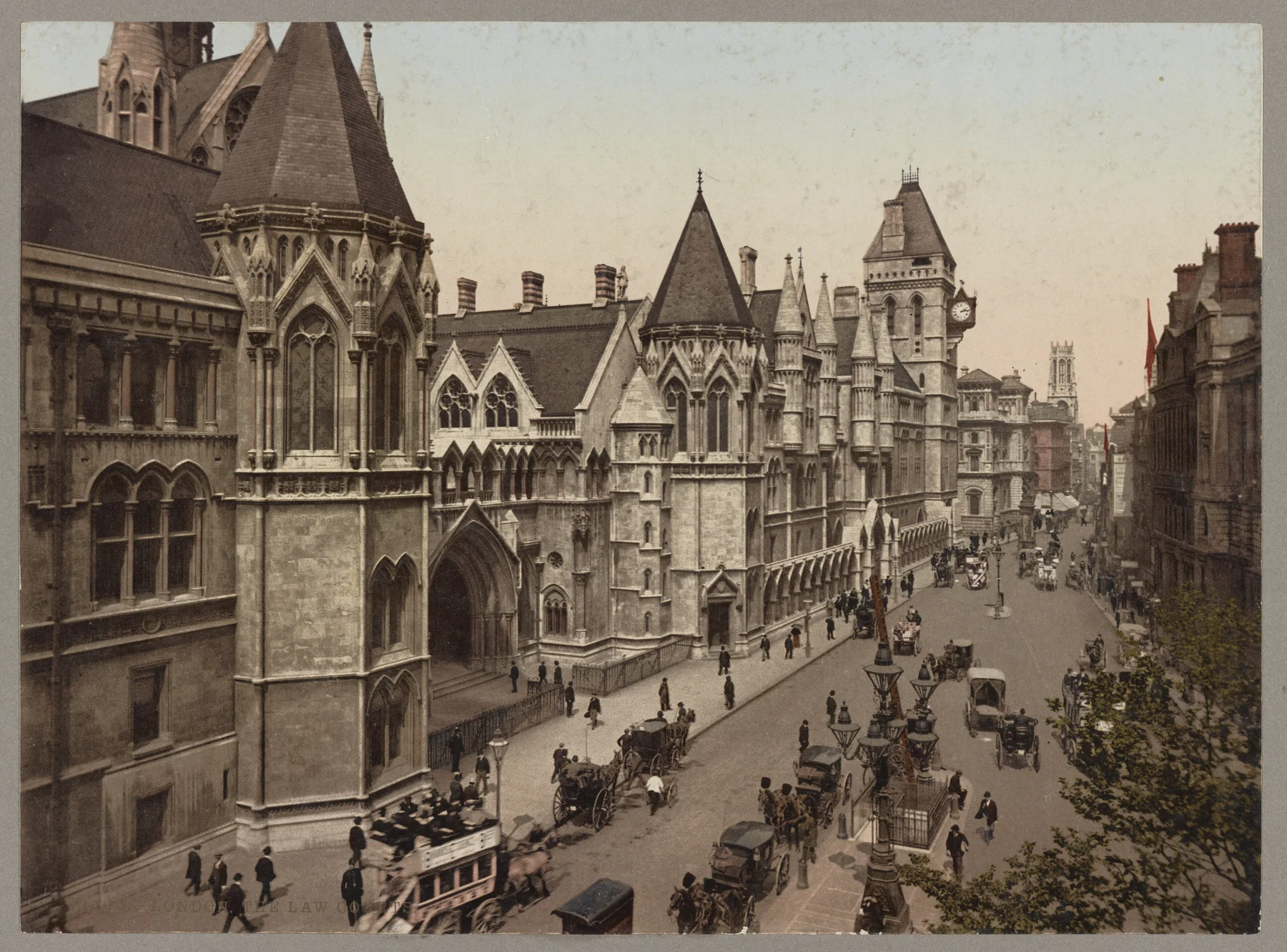 Historic photochrom of the Royal Courts of Justice and horse-drawn traffic on the Strand around 1890